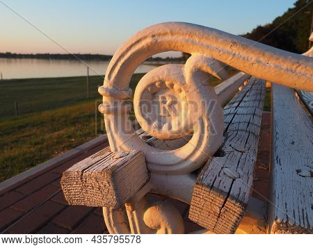 Palic, Serbia September 10, 2021. Metal Bench Overlooking Lake Palic. The Seat Is White. R Letter On