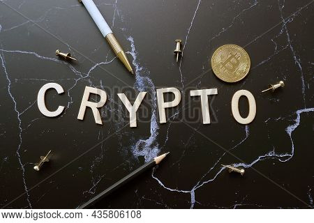 Flatlay Wood Text Crypto With Pen And Coin On 
Desktop Background.for Crypto Currentcy Concept.