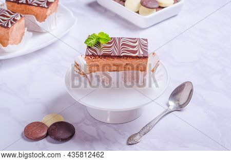 Chocolate Brownie Bird Milk With Frosting On White Plate