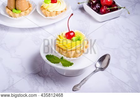 Tartlet Cake Filled With Fruit Cream On A White Plate