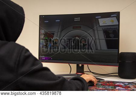 Vilnius, Lithuania - October 09, 2021: Teenager Playing Video Game Squid Game On Computer At Home. S