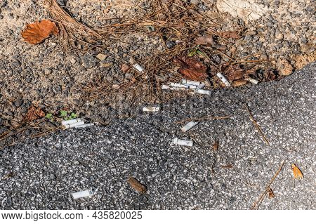 Cumming, Georgia Usa - October 09, 2021  Several Used Cigarette Butts Dumped On The Ground At The Ed