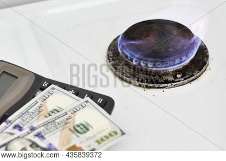 Burning Gas Stove Burner, Calculator And Us Dollar Banknotes. Pay For Natural Gas, Bill, Tariff. Pil