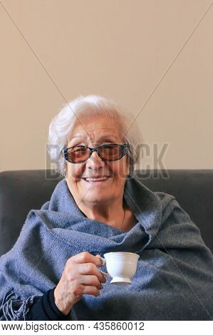 Portrait Of A Very Elderly Woman Drinking Coffee. Positive Ninety Year Old Grandmother