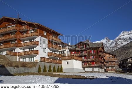 Switzerland, Saas-fee, December, 2015 - Modern Wooden Hotels On A Bright Sunny Day In The Charming S