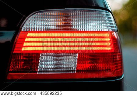 Included Red Headlight Auto. Close-up Of A Headlight.