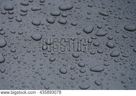 Closeup Of Raindrops On Dark Glass Background