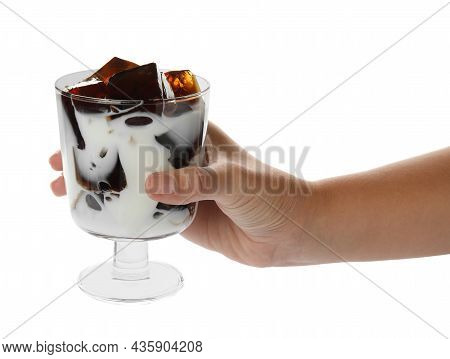 Woman Holding Glass Of Milk With Delicious Grass Jelly On White Background, Closeup