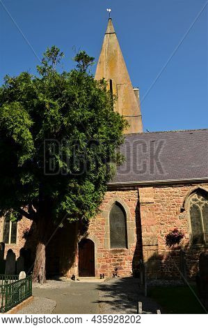 An Exterior View Of The Stone Church Building In The Town Of Grouville On The Island Of Jersey.