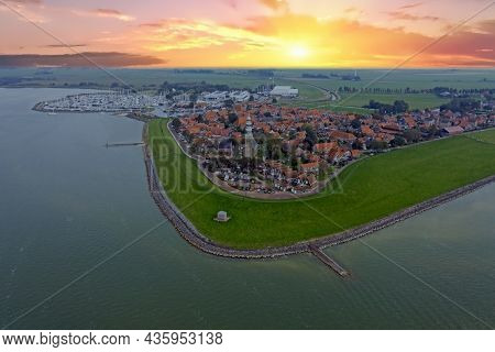 Aerial from the historical city Hindeloopen in Friesland the Netherlands at sunrise