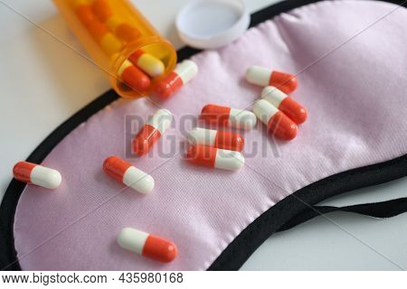 Multi-colored Pills Lie On Sleep Mask Closeup
