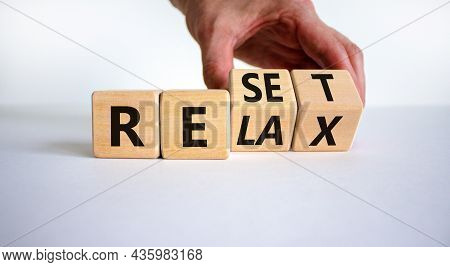 Relax And Reset Symbol. Businessman Turns Cubes And Changes The Word 'relax' To 'reset'. Beautiful W