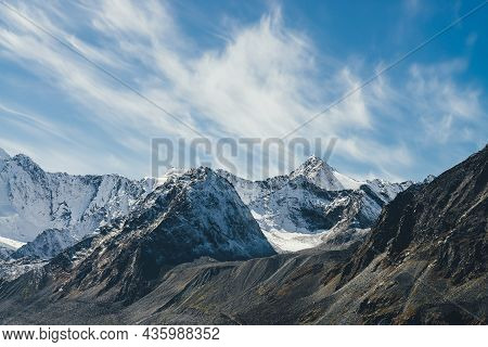 Alpine Landscape With High Snowy Mountain With Peaked Top Under Cirrus Clouds In Sky. Atmospheric Vi