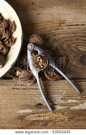 Walnuts Cracked Open With Old Nut Cracker In A Vintage Plate On A Wooden Table