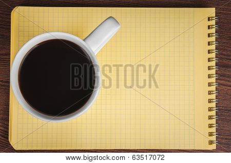 Blank notepad and coffee cup