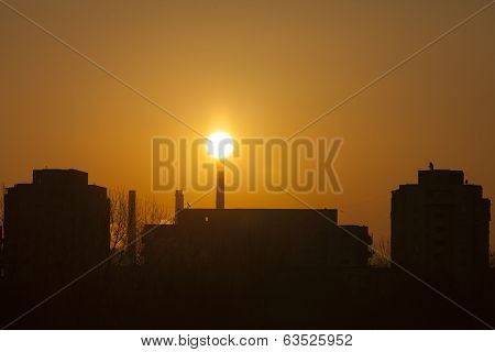 Winter Scenic Of Power Plant With A Burning Red Clouds Behind