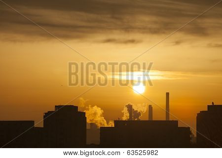Winter Scenic Of Power Plant With A Burning Red Clouds Behind