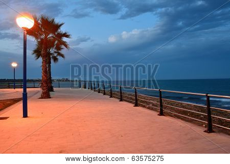 Stone beach promenade at sunset