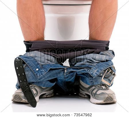 Man is sitting on the toilet bowl