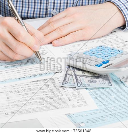 Male Filling Out 1040 Usa Tax Form - Studio Shot