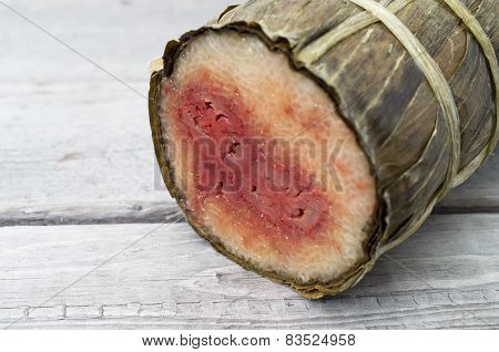 Vietnamese conical sticky rice cake stuffed banana on wooden background