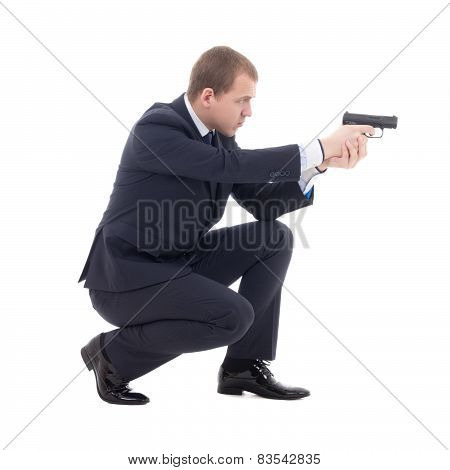 Special Agent Man In Business Suit Sitting And Shooting With Gun Isolated On White
