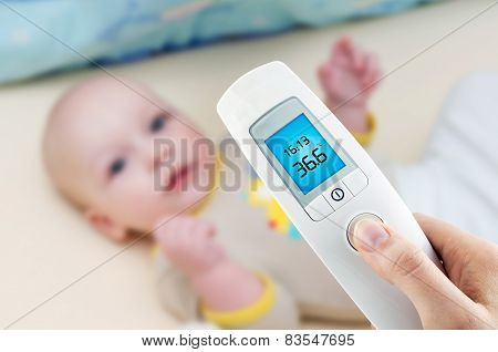 Measuring Temperature To A Baby With Digital Thermometer