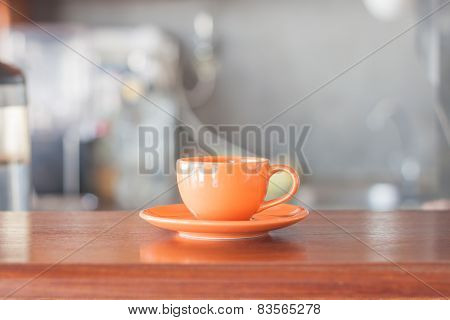 Mini Orange Coffee Cup In Coffee Shop