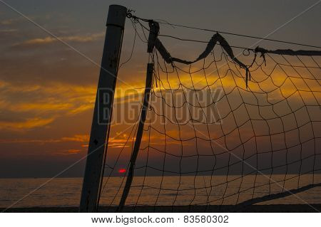 Some part of the volleyball net at sunset