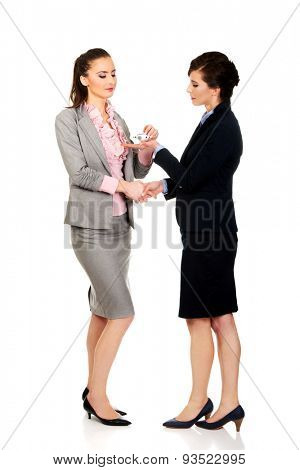 Caucasian businesswoman giving a plane to her partner.