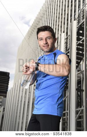 Young Sport Man Checking Time On Chrono Timer Runners Watch Holding Water Bottle After Training Sess