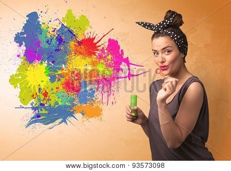 Cute girl blowing bubble spalsh graffiti into wall