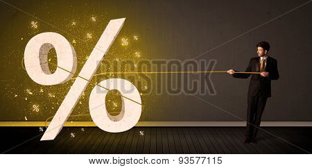 Business man pulling rope with big procent symbol sign concept on background