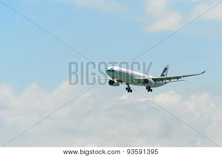 HONG KONG - JUNE 04, 2015: Cathay Pacific aircraft landing. Cathay Pacific is the flag carrier airline of Hong Kong, with its head office and main hub located at Hong Kong International Airport