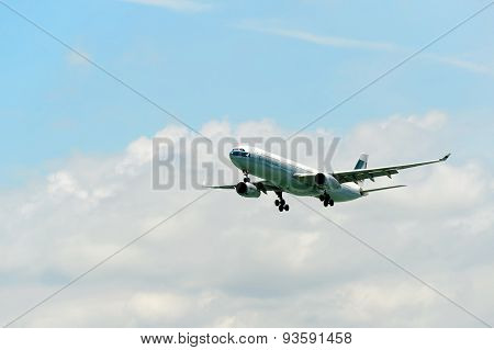 HONG KONG - JUNE 04, 2015: Cathay Pacific aircraft landing. Cathay Pacific is the flag carrier airline of Hong Kong, with its head office and main hub located at Hong Kong International Airport