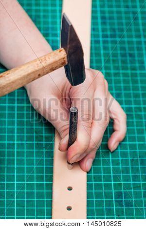 Punching Leather Belt With Hole Punch And Hammer