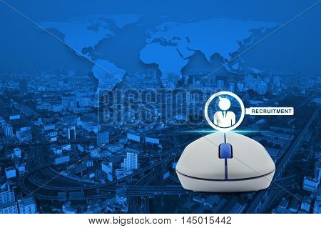 Wireless computer mouse with businessman and magnifying glass icon over city tower street and expressway Recruitment concept Elements of this image furnished by NASA