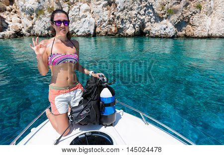 Female scuba diver shows the 