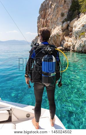 Male scuba diver watches the scene from the diving boat