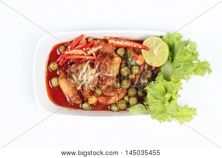 Spicy fried chicken in roasted chili sauce on white background.
