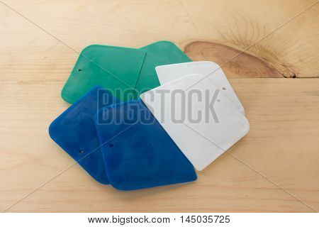 plastic putty spattles on wood background .