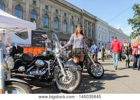 St. Petersburg, Russia - 12 August, Girl in a striped vest on motorbikes background,12 August, 2016.
The annual International Festival of Motor Harley Davidson in St. Petersburg Ostrovsky Square.
