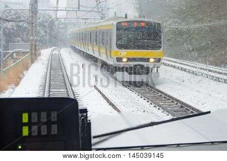 tokyo Japan - February 8 2014 train speeding through the snow in tokyo japan