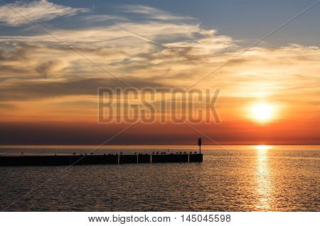 The colors of the sunset over the Baltic Sea in Kolobrzeg in Poland