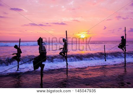 AHANGAMA - NOVEMBER 27 : Still fisherman's fishing fish at sunset on November 27 2015 in Ahangama Sri Lanka