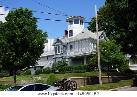 A Victorian mansion, with a wraparound porch and an observation tower, on Lake Street near downtown Petoskey, Michigan.
