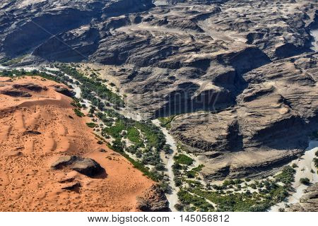 Aerial view on the beautiful landscape of the Kuiseb canyon in Namib desert at sunset. Flying on a small plane over the desert is one of the most popular tourist attractions in Namibia