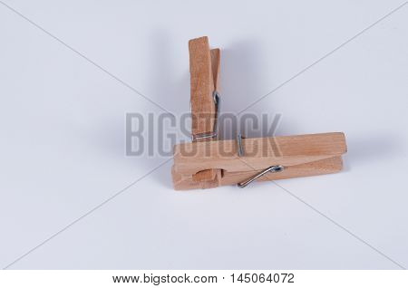 Pair of wooden cloth pegs on white background.