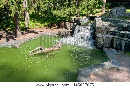 IMATRA, FINLAND - JULY 2, 2016: Maiden of Imatra Sculpture and Fountain in Kruununpuisto Park next to the Imatrankoski Rapid on the Vuoksi River
