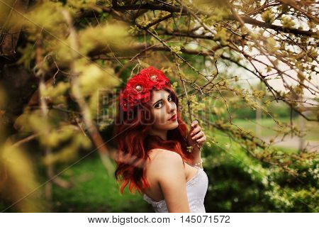 The girl with red hair on a green background